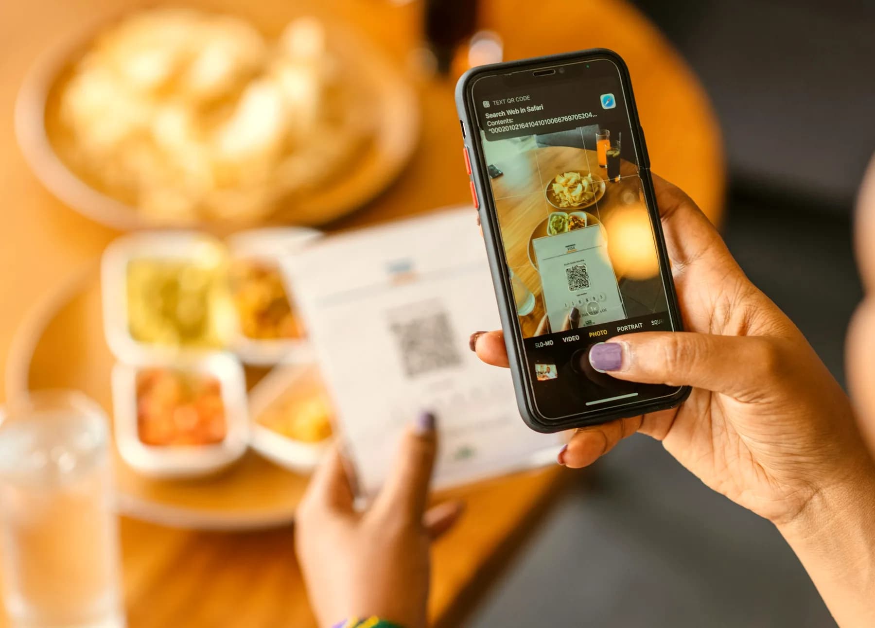 A guest scanning a table QR code to see the menu